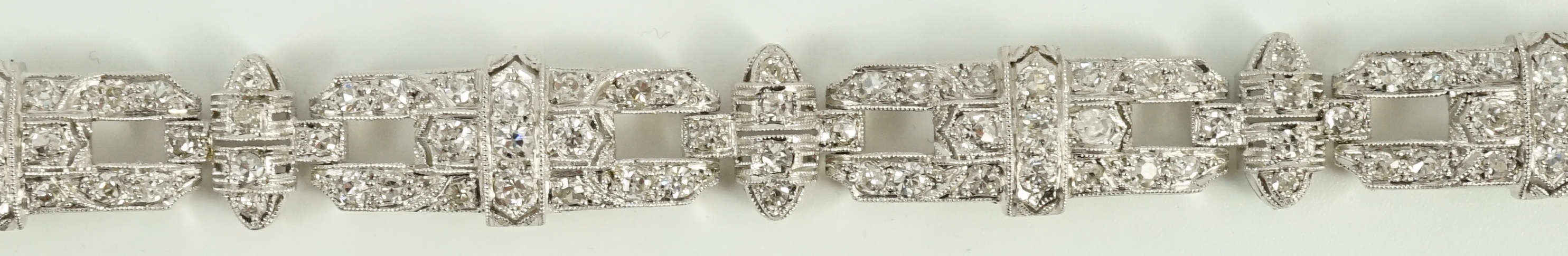 An Art Deco style pierced platinum and diamond cluster set bracelet